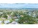 Scenic aerial view showcasing home amidst lush greenery, near waterfront and community amenities at 5871 Oakhurst Dr, Seminole, FL 33772