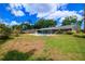 Large backyard featuring an in-ground pool and mature trees at 5871 Oakhurst Dr, Seminole, FL 33772