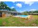 Backyard showcasing the pool and covered patio at 5871 Oakhurst Dr, Seminole, FL 33772
