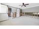Bedroom featuring a modern ceiling fan, barn door entrance, and natural light from windows for a serene space at 5871 Oakhurst Dr, Seminole, FL 33772