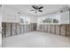 Bright bedroom featuring a ceiling fan, white windows and white walls at 5871 Oakhurst Dr, Seminole, FL 33772