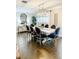 Elegant dining room with stylish seating, modern chandelier, and hardwood floors at 5871 Oakhurst Dr, Seminole, FL 33772