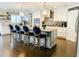 Bright, open kitchen showcasing a large island with seating, stainless steel appliances, and hardwood floors at 5871 Oakhurst Dr, Seminole, FL 33772