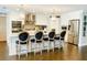 Modern kitchen with stainless steel appliances, kitchen island with seating, and beautiful hardwood floors at 5871 Oakhurst Dr, Seminole, FL 33772