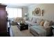 Cozy living room featuring a comfortable sectional sofa, stylish decor, and ample natural light at 5871 Oakhurst Dr, Seminole, FL 33772