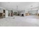 Open living space showcasing a brick fireplace and an airy layout with multiple doorways and large windows at 5871 Oakhurst Dr, Seminole, FL 33772