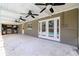 Spacious covered patio with ceiling fans and an outdoor kitchen at 5871 Oakhurst Dr, Seminole, FL 33772