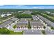 Wide aerial view of the Avila Point community, showcasing townhomes, landscaping, and surrounding areas at 6031 Grand Sonata Ave, Lutz, FL 33558
