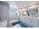 Bright bathroom features a double vanity with marble countertops and a glass-enclosed shower at 6031 Grand Sonata Ave, Lutz, FL 33558