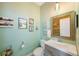 Stylish half bathroom with modern vanity, framed mirror, and decorative wall art at 6031 Grand Sonata Ave, Lutz, FL 33558