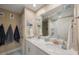 Charming bathroom with double sinks, neutral walls, decorative starfish garland, and coordinated hooks provides a refreshing space at 6031 Grand Sonata Ave, Lutz, FL 33558