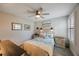 Comfortable bedroom features coastal decor, fan, neutral paint, and shuttered windows for a serene and inviting atmosphere at 6031 Grand Sonata Ave, Lutz, FL 33558