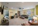 Large bonus room with a comfortable sitting area, desk space, ceiling fan, and natural light from multiple windows at 6031 Grand Sonata Ave, Lutz, FL 33558
