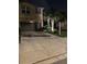 Two story home with a two car garage, lush landscaping, and a real estate sign at night at 6031 Grand Sonata Ave, Lutz, FL 33558