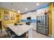 Contemporary kitchen featuring quartz counters, stainless steel appliances, and an island with seating at 6031 Grand Sonata Ave, Lutz, FL 33558
