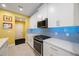 Bright kitchen featuring white cabinets, stainless steel appliances, and blue backsplash at 6031 Grand Sonata Ave, Lutz, FL 33558