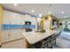 Modern kitchen with stainless steel appliances, quartz countertops, and a breakfast bar at 6031 Grand Sonata Ave, Lutz, FL 33558