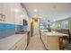 Well-lit kitchen with stainless steel appliances, an island and seamless flow to dining and living areas at 6031 Grand Sonata Ave, Lutz, FL 33558