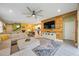 Open concept living room boasts a wood feature wall, white cabinets and an eat in kitchen at 6031 Grand Sonata Ave, Lutz, FL 33558