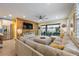 Bright living room boasts a wood accent wall, tile floors, and sliding glass doors to the outdoor patio at 6031 Grand Sonata Ave, Lutz, FL 33558