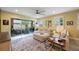 Open-concept living room features a large sectional sofa, area rug, and sliding glass doors to the outdoor patio at 6031 Grand Sonata Ave, Lutz, FL 33558