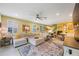 Bright living room featuring a large sectional sofa, open layout, and view of the dining area at 6031 Grand Sonata Ave, Lutz, FL 33558