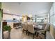 Open-concept living space with tile floors, dining area, and a modern kitchen with stainless steel appliances at 6031 Grand Sonata Ave, Lutz, FL 33558