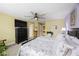 Primary bedroom features a television, ceiling fan, and ensuite bathroom at 6031 Grand Sonata Ave, Lutz, FL 33558