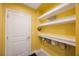 Practical mudroom with built-in shelves and door at 6031 Grand Sonata Ave, Lutz, FL 33558