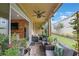 Covered patio offers a cozy seating area with views of the lawn and access to the home's interior at 6031 Grand Sonata Ave, Lutz, FL 33558
