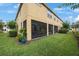 View of the screened lanai, extending from the rear of the townhome, surrounded by a well-maintained lawn at 6031 Grand Sonata Ave, Lutz, FL 33558