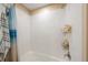 Clean and bright tiled shower features shower head and convenient storage shelves for toiletries and personal care items at 6031 Grand Sonata Ave, Lutz, FL 33558