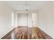 Bedroom features hardwood floors, a ceiling fan, closet and door to ensuite bathroom at 6058 Waycross Dr, Spring Hill, FL 34606
