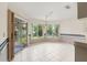 Sunny breakfast nook with tile flooring, large windows offering backyard views, and access to the patio at 6058 Waycross Dr, Spring Hill, FL 34606