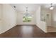 Bright dining room showcasing wood floors, a chandelier, and a large window with a backyard view at 6058 Waycross Dr, Spring Hill, FL 34606