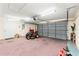Garage featuring an automatic garage door, garage door opener, and standard entry door at 6058 Waycross Dr, Spring Hill, FL 34606