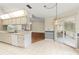 Kitchen with white cabinetry, white tile flooring, and open layout into the dining area at 6058 Waycross Dr, Spring Hill, FL 34606