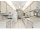 Functional kitchen with white appliances, tile flooring, and ample cabinet space, ready for modern upgrades at 6058 Waycross Dr, Spring Hill, FL 34606