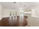 Bright living room with hardwood floors, ceiling fan, and sliding glass doors to the backyard at 6058 Waycross Dr, Spring Hill, FL 34606