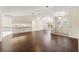 Inviting living room featuring wood floors, high ceilings, and a seamless flow to the kitchen at 6058 Waycross Dr, Spring Hill, FL 34606