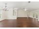 Spacious living room featuring hardwood flooring, ceiling fans, and ample natural light at 6058 Waycross Dr, Spring Hill, FL 34606