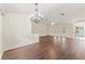 Open-concept living room features hardwood floors and natural light from sliding glass doors at 6058 Waycross Dr, Spring Hill, FL 34606