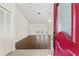 Open floor plan featuring wood floors, a ceiling fan, and access to the backyard through French doors at 6058 Waycross Dr, Spring Hill, FL 34606