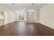Bright living room features hardwood floors, ceiling fan, and front door with glass inserts at 6058 Waycross Dr, Spring Hill, FL 34606