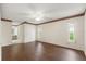 Spacious main bedroom with wood floors, a ceiling fan, dual windows, and an en-suite bathroom at 6058 Waycross Dr, Spring Hill, FL 34606