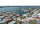 Beautiful aerial view showcases a waterfront property surrounded by lush greenery at 6405 2Nd Palm Pt, St Pete Beach, FL 33706