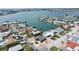 This aerial view shows a coastal community with waterfront homes, docks, and a view of the city skyline at 6405 2Nd Palm Pt, St Pete Beach, FL 33706