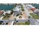 Aerial view of a waterfront home with mature landscaping, and a circular driveway at 6405 2Nd Palm Pt, St Pete Beach, FL 33706