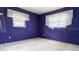 A bedroom with purple walls and sheer white curtains offers a simple, calming space at 6405 2Nd Palm Pt, St Pete Beach, FL 33706