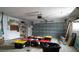 A spacious garage with ample storage and a roll-up door offers a versatile space for projects at 6405 2Nd Palm Pt, St Pete Beach, FL 33706
